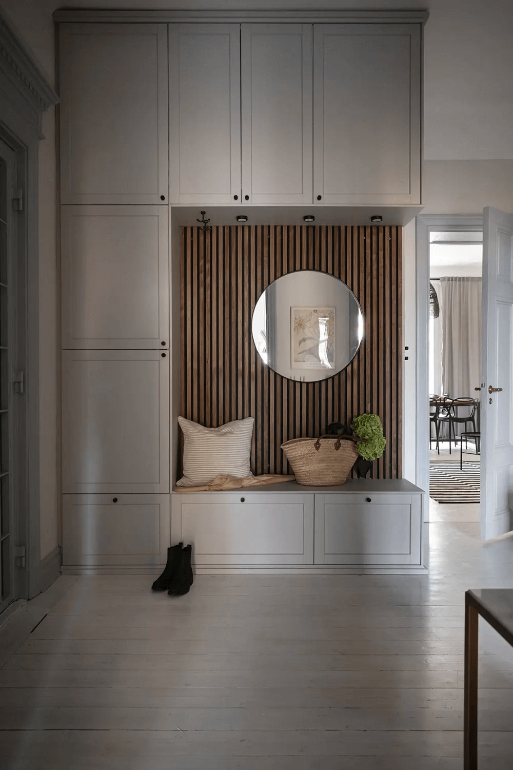 A historic apartment with a light grey kitchen and grey wainscoting