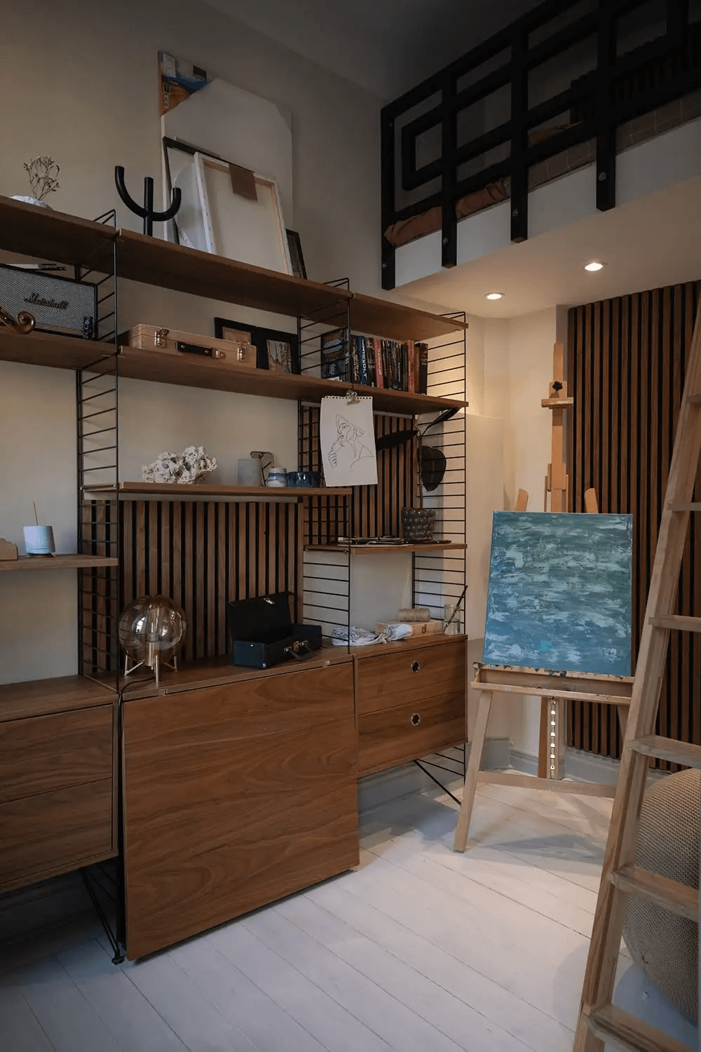 A historic apartment with a light grey kitchen and grey wainscoting